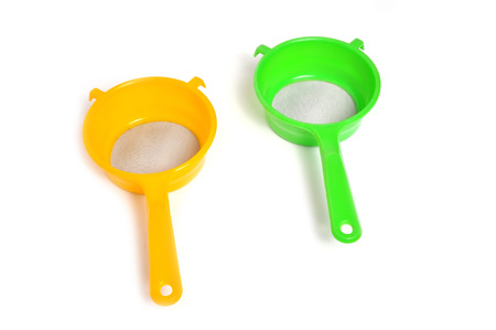 Yellow and Green handle colander isolated on white backgroundの写真素材