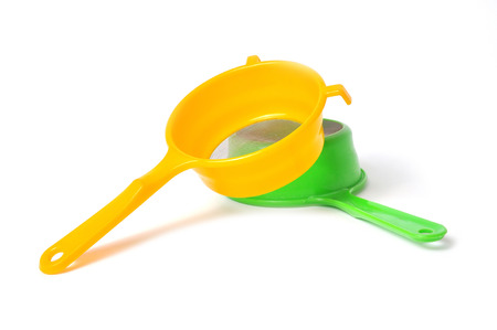 Yellow and Green handle colander isolated on white backgroundの写真素材