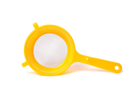 Yellow handle colander isolated on white backgroundの写真素材