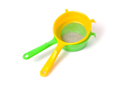 Yellow and Green handle colander isolated on white backgroundの写真素材