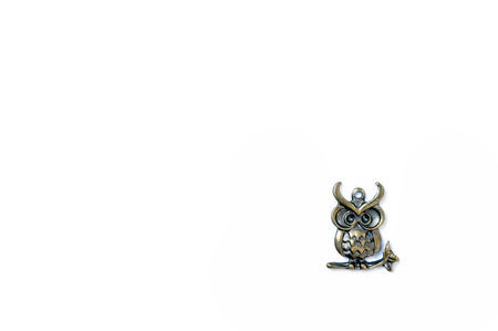 metal owl isolated at corner on white backgrkoundの写真素材