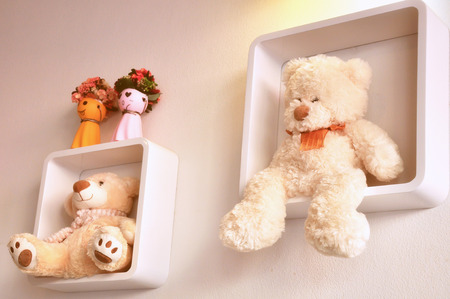 Teddy bear on shelves in the living roomの写真素材