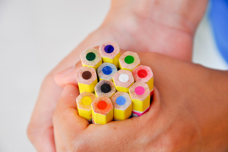 A brightly colored pencils in her handful.の写真素材