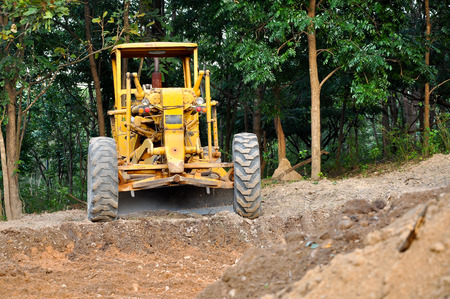 Graders are commonly used in the construction and maintenance of dirt roads and gravel roads.の写真素材