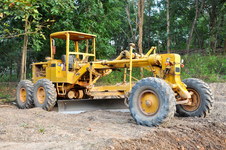 Graders are commonly used in the construction and maintenance of dirt roads and gravel roads.の写真素材