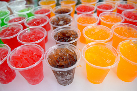 fancy soft drink with ice in plastic cupの写真素材