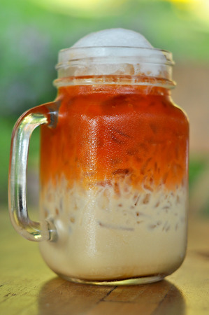 Thai cold milk tea was put in a glass with a handle.の写真素材