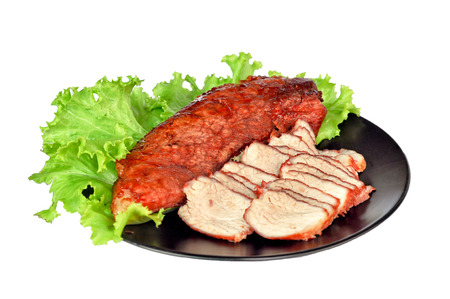 Roasted red pork on a green salad in a black plate.の写真素材