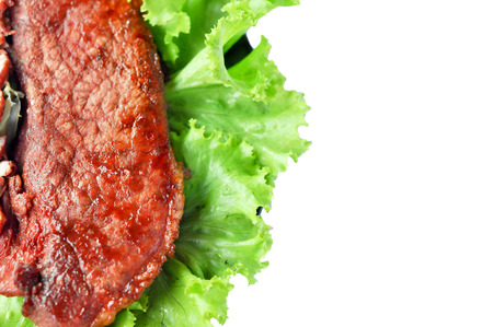 Roasted red pork on a green salad in a black plate.の写真素材
