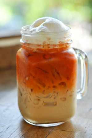 Thai cold milk tea was put in a glass with a handle.の写真素材