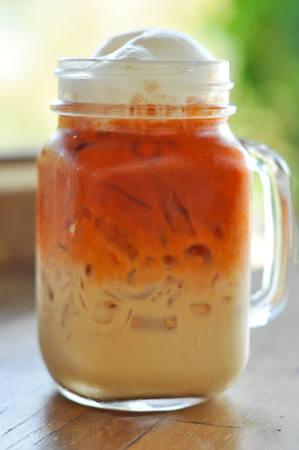 Thai cold milk tea was put in a glass with a handle.の写真素材