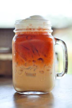 Thai cold milk tea was put in a glass with a handle.の写真素材