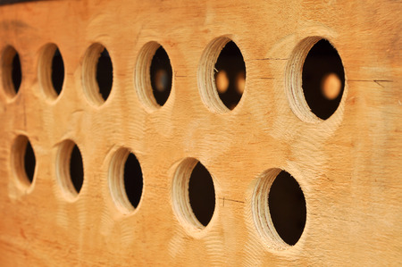 Round hole on the plywood used for the ventilation of the cargo box.の写真素材