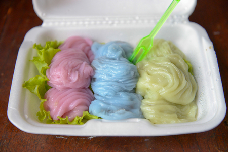 Thai snak made with rice flour smear on the cloth stretched mouth boiling cauldron. A filling made with shrimp or pork.の写真素材