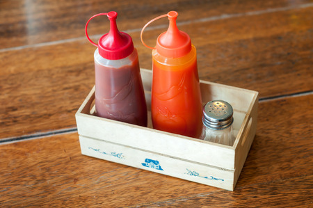 Ketchup and chilli sauce in small wooden boxの写真素材