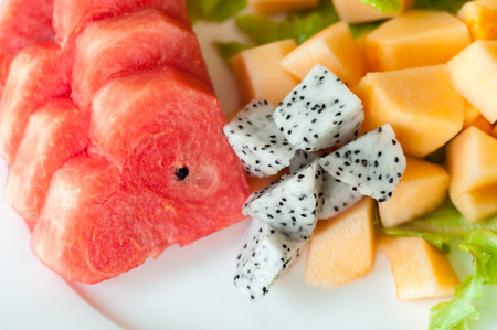 Fresh fruit after meals, including watermelon, cantaloupe and dragon fruit.の写真素材