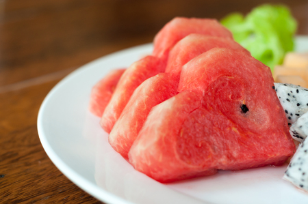 Fresh fruit after meals, including watermelon, cantaloupe and dragon fruit.の写真素材