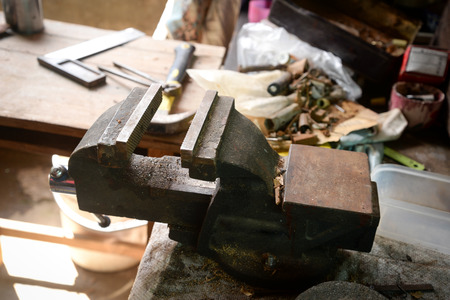 bench vise on the table with the other hardware equipment