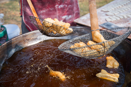 Merchant is making Chinese fried dough for sale.の写真素材