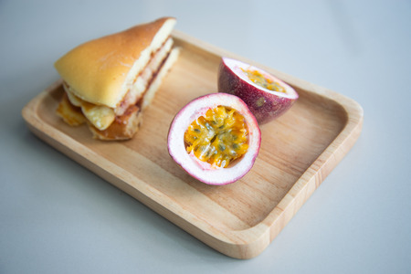 pancake and passion fruit on wood plateの写真素材