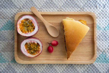 pancake and passion fruit on wood plateの写真素材