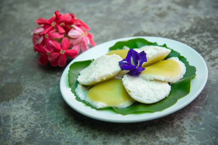 Steamed Coconut Milk Custard (Kanom Touy) have two layers. The first layer is a mixture of flour, coconut milk. Coconut Sugar and Pandan Juice The second layer is a mixture of flour, coconut milk and salt.の写真素材