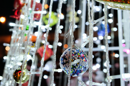 Lovely decorations on Christmas trees with beautiful bokeh from the lightsの写真素材