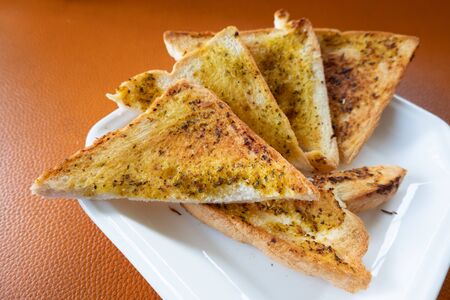 Triangular garlic bread for breakfastの写真素材