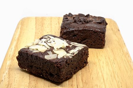 chocolate chip and almond brownies on wood plateの写真素材