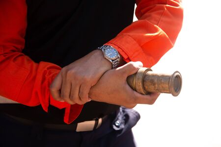 How to hold a fire hose nozzle of a firefighterの写真素材