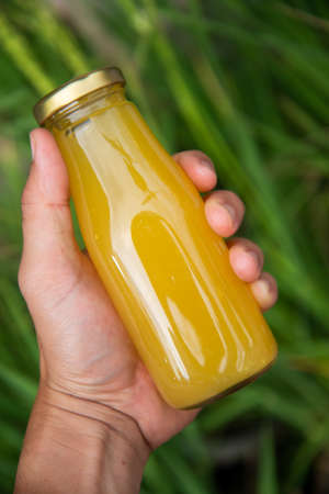 Fresh pineapple juice in bottled, produced from an organic pineapple farm.の写真素材