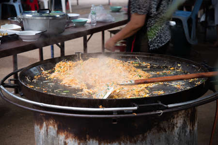 Newly cooked Pad Thai in a large iron pan.の写真素材