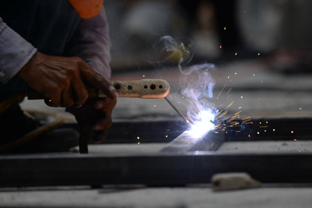 The laborer is welding steel in the construction.の写真素材