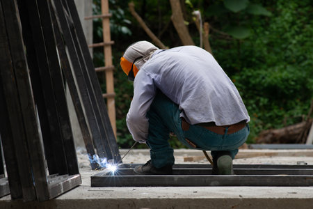 The laborer is welding steel in the construction.の写真素材