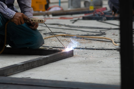 The laborer is welding steel in the construction.の写真素材
