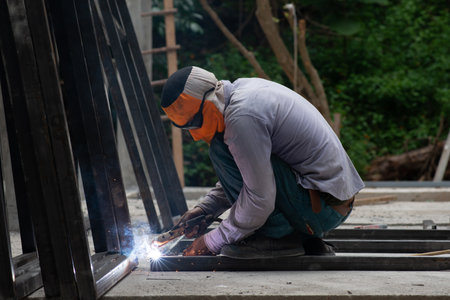 The laborer is welding steel in the construction.の写真素材