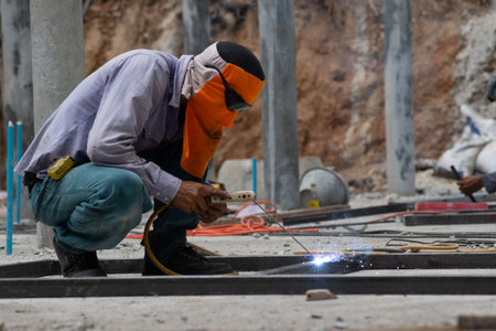 The laborer is welding steel in the construction.の写真素材