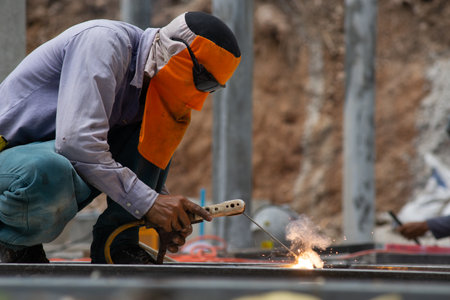 The laborer is welding steel in the construction.の写真素材