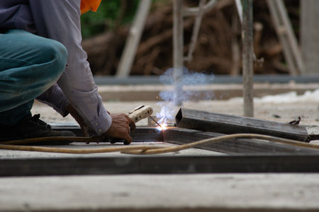 The laborer is welding steel in the construction.の写真素材
