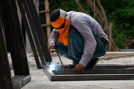 The laborer is welding steel in the construction.の写真素材