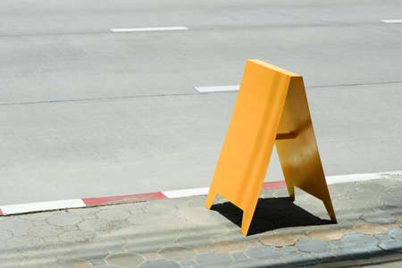 Blank yellow outdoor advertising stand/sandwich board mock up templateの写真素材