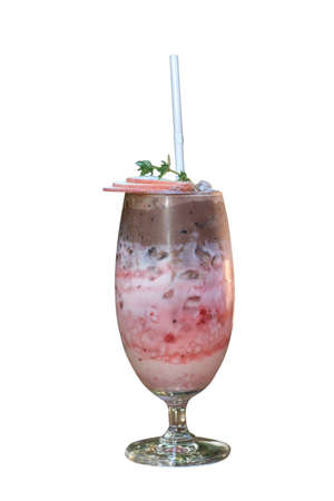 The iced strawberry drink is topped with a chocolate smoothie isolatedの写真素材