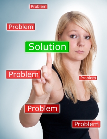woman pressing solution button on blue backgroundの写真素材