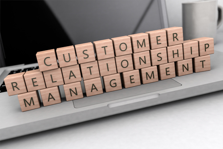 Customer Relationship Management - wooden letters on notebook computer - 3d render illustration.の写真素材