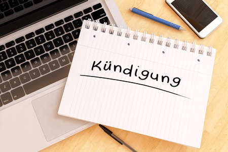 Kuendigung - german word for termination or cancellation - handwritten text in a notebook on a desk - 3d render illustration.の写真素材