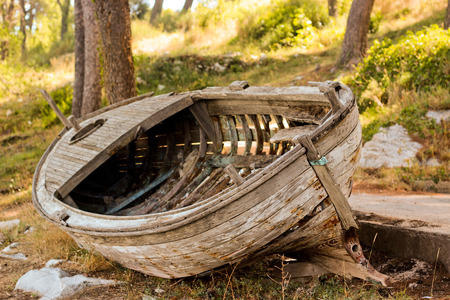 Leaky old boat on the shoreの写真素材