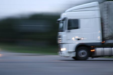 White truck on extreme high speed. Motion blur, shot on evening.の写真素材