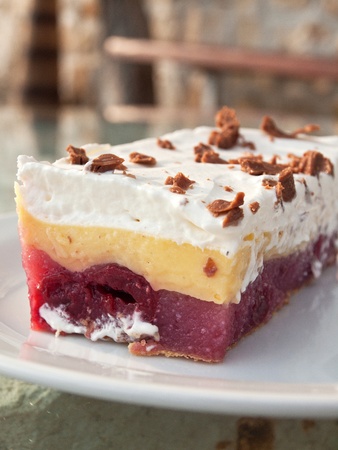 Colorful fruit cake on plate outdoorの写真素材