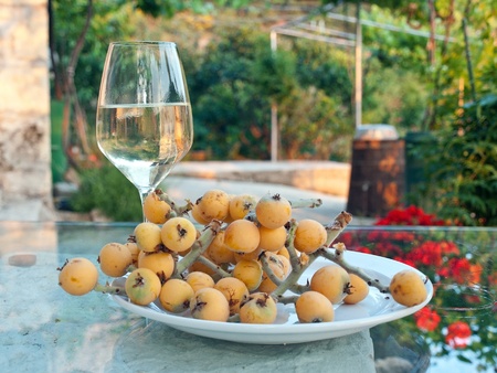 Glass of white wine with traditional mediterranean fruitの写真素材