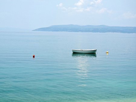 View at island Hvar and small boat on blue seaの写真素材